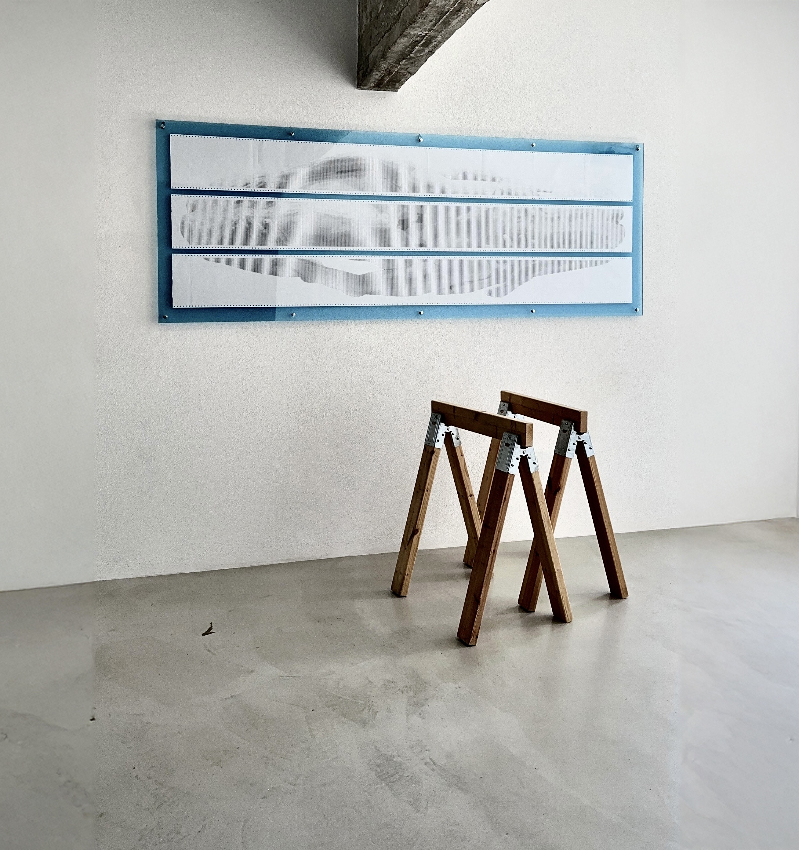 BODY.QUEUE by CHARACTERS shown with sawhorses for scale — three-sheet ASCII scroll, 72 × 252 cm, dot-matrix print on deadstock continuous-feed paper. 2025.