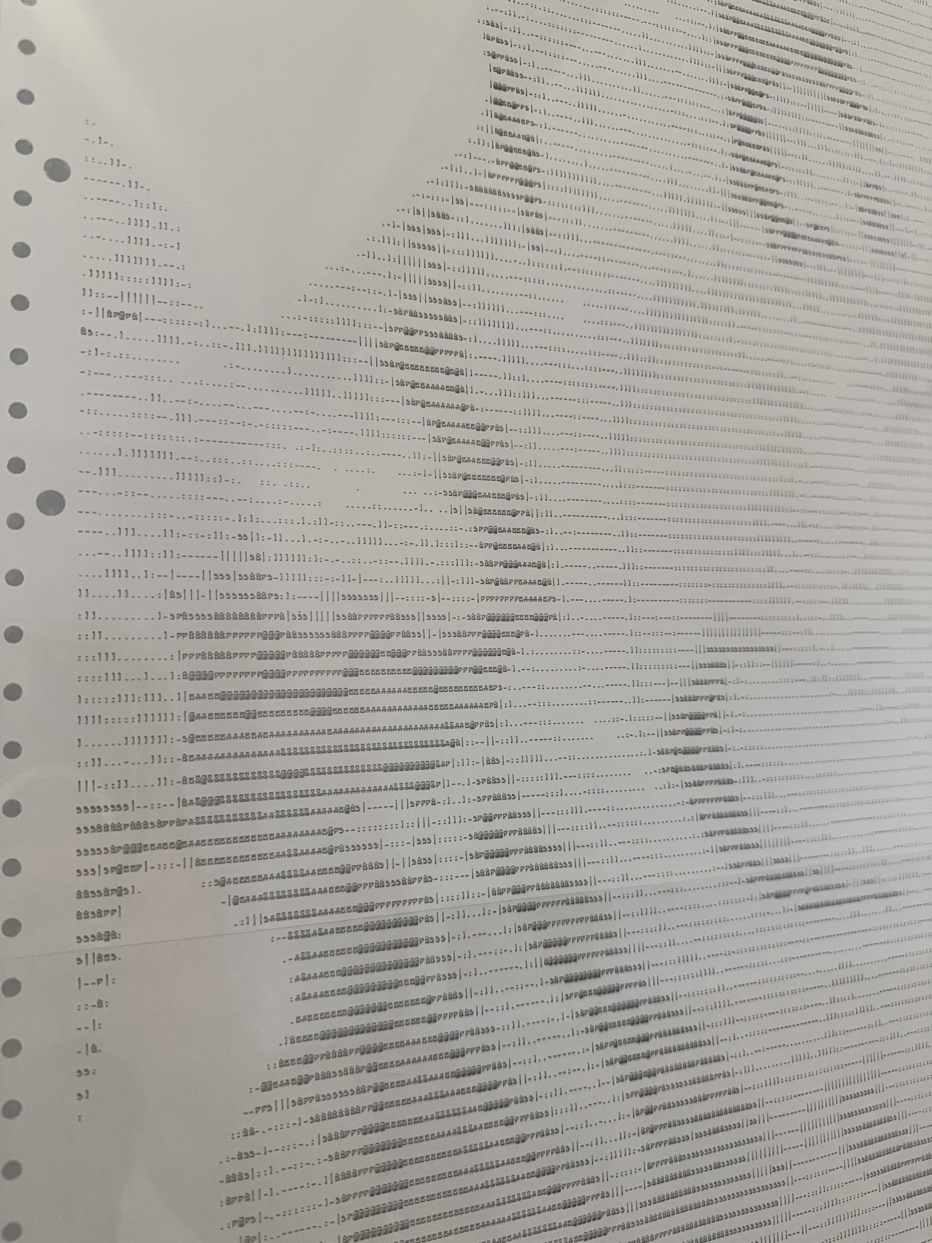 Detail of INPUT.OVERRIDE by CHARACTERS — ASCII character grid on salvaged dot-matrix paper showing broken facial contours and figure rendered in monospaced characters. 2022.