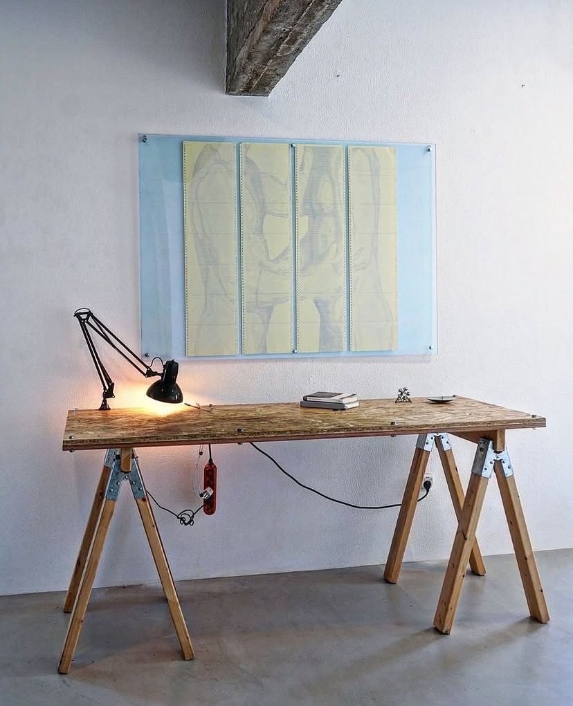 (TXT)TOUCH by CHARACTERS shown in studio with nearby furniture for scale — four-sheet ASCII scroll, 96 × 96 cm, dot-matrix print on deadstock continuous-feed paper. 2025.